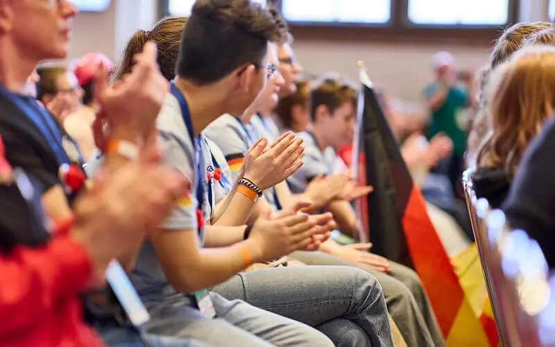 Audience applauding at the D-A-CH final with national flags